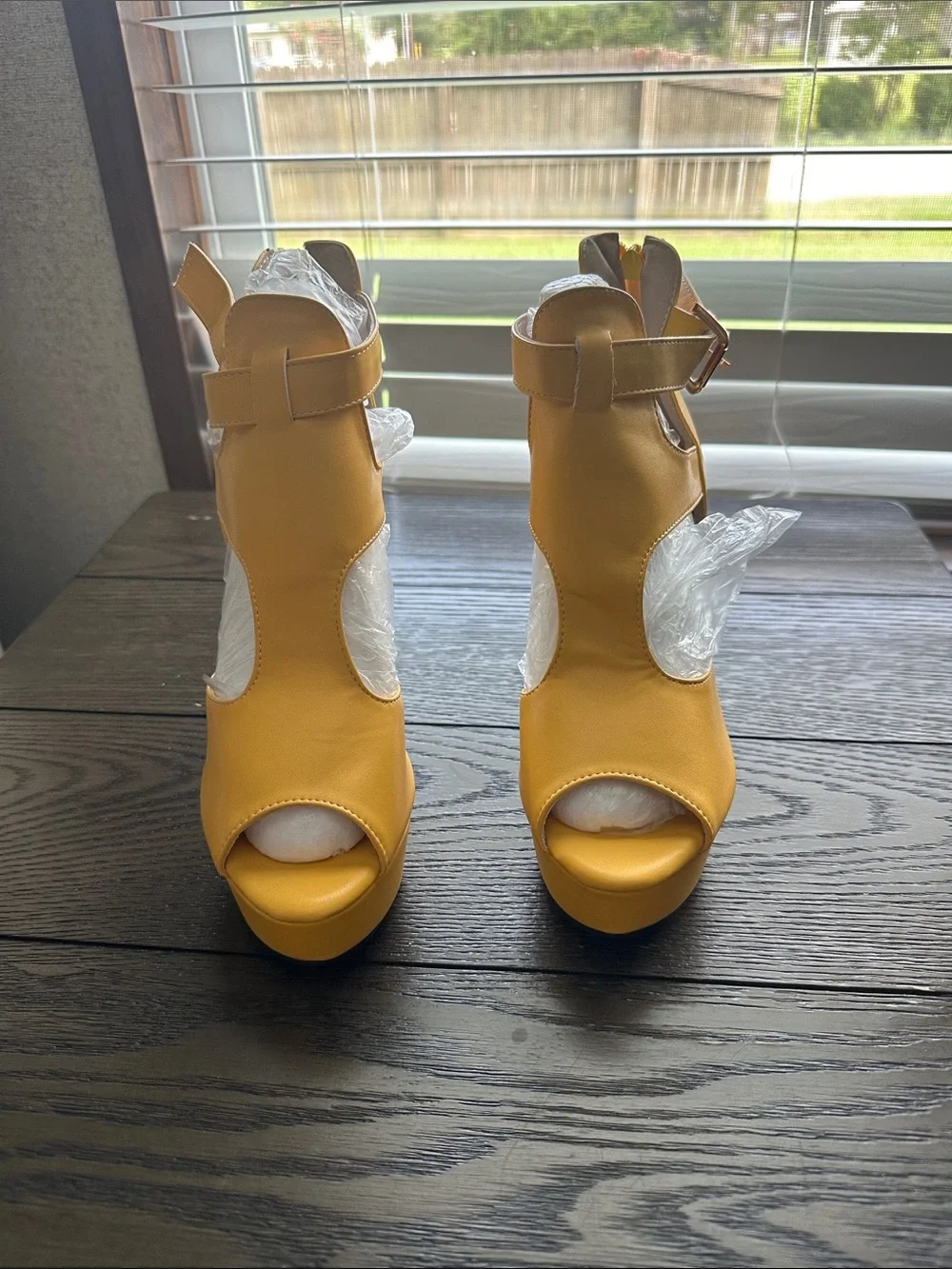 Fereshte mustard yellow peep toe high heel ankle booties.